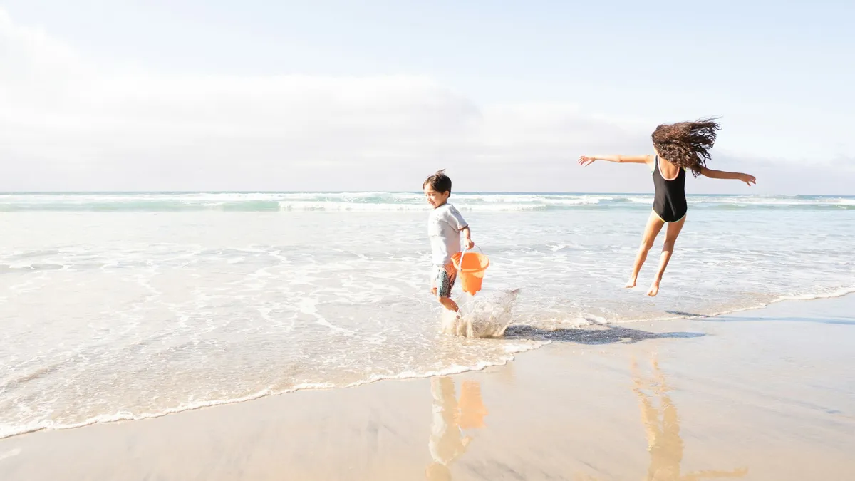 Dos niños jugando en la orilla de la playa